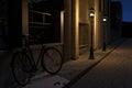 3d rendering of old town street with leaning bicycle and showcase with lighten lantern at night