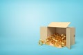 3d rendering of open cardboard box lying sidelong full of golden crowns on light-blue background with much copy space.