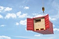3d rendering of open red cargo container full of cardboard packages, suspended from crane. Royalty Free Stock Photo