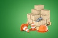 3d rendering of orange hard hat and two warning cones in front of wooden pallet loaded with cardboard boxes and one