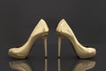 3D rendering of a pair of golden high heels