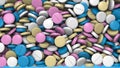3D rendering pile of pink, blue, white, beige round pills. Computer graphics of medical tablets with a glossy surface