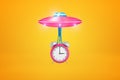 3d rendering of pink UFO with big pink alarm clock suspended on slime below it, flying against amber background.