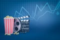 3d rendering of popcorn bucket, film reel and clapperboard against blue background with line graphs and some copy space. Royalty Free Stock Photo