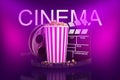 3d rendering of popcorn bucket, film reel, movie clapper with CINEMA sign above on neon pink background Royalty Free Stock Photo