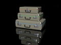 3D rendering. Pyramid of three old-fashioned gray suitcases