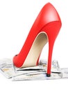 Closeup of female red highheel stepping on pile of money