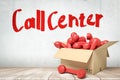 3d rendering of red retro telephone receivers in a cardboard box with `Call center` sign on white wooden floor Royalty Free Stock Photo