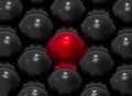 3d rendering. A red sphere balls Surrounded by the other blacks. Leadership or Outstanding from group in business concept Royalty Free Stock Photo