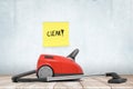 3d rendering of red vacuum cleaner on wooden floor near concrete wall where someone had stuck post-it note `Clear`