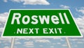 Green highway sign for Roswell next exit