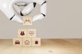 3d rendering Robot hand pick insurance concept, wooden cube symbolize put the insurance to protect or cover person, Property ,Liab