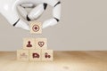 3d rendering Robot hand pick smart health care, insurance concept, wooden cube symbolize insurance to protect or cover person, Pro