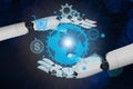 The 3D rendering of the robotic hand surrounds the globe, touching digital technology and virtual and artificial Royalty Free Stock Photo