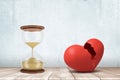 3d rendering of sandglass and red broken heart on white floor and white wall background Royalty Free Stock Photo