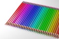 3D rendering a set of beautiful even rainbow colored pencils on a white isolated background.