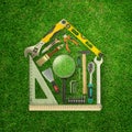 3d rendering of set of construction tools shaped as house on green grass background Royalty Free Stock Photo