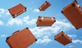 3d rendering of a several brown retro suitcases closed with buckles flying on cloudy sky background.