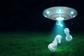 3d rendering of silver metal UFO with chess pieces on dark night sky and green grass background