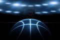 3D rendering of single black basketball with bright blue glowing neon lines in under illuminated floodlights. Royalty Free Stock Photo