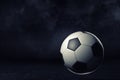 3d rendering of a single football ball on a dark background under bright spotlight. Royalty Free Stock Photo