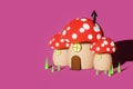 3D rendering of a small red mushroom house on pink background Royalty Free Stock Photo