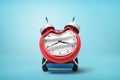 3d rendering of smashed broken alarm clock on a hand truck on blue background