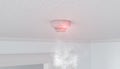 3d rendering of a smoke detector mounted on the ceiling of an apartment Royalty Free Stock Photo