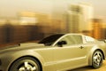 A sport car speeding in front of a skyline