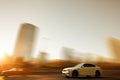 A sport car speeding in front of a skyline