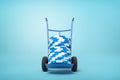 3d rendering of stack of blue and white poker chips on blue hand truck on light-blue background with copy space.