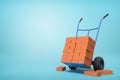 3d rendering of stack of red perforated bricks on blue hand truck with several bricks on ground on light-blue background Royalty Free Stock Photo