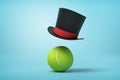 3d rendering of tennis ball and black tophat floating in air above it on light blue background. Royalty Free Stock Photo