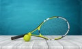 3d rendering of tennis racket and yellow tennis ball on white wooden floor and dark turquoise background