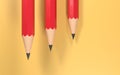 3d rendering of three red pencils on a yellow background Royalty Free Stock Photo