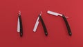 3d rendering. three straight razors with a wooden handle on a red Royalty Free Stock Photo