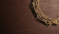 crown of thorn placed on wooden table