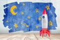 3d rendering of a toy space rocket standing at the wall with a children`s drawing of a starry sky. Royalty Free Stock Photo