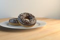3d rendering of two chocolate-covered donuts on a plate Royalty Free Stock Photo