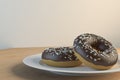 3d rendering of two chocolate-covered donuts on a plate Royalty Free Stock Photo