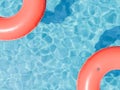 Red Swim Rings Floating on Glistening Pool Water Royalty Free Stock Photo