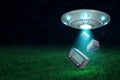 3d rendering of UFO with open hatch under night sky dropping three retro radio sets onto green field.