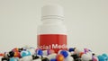 various popular social media logos as drug pills surrounding a white bottle. social media addiction concept