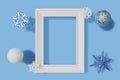 3d rendering vertical picture frame mockup, snowflakes and balls with frosty texture on a blue background