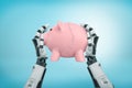 3d rendering view from above of robot hands holding tight piggy bank broken in halves on light-blue background.
