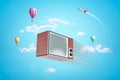 3d rendering of a vintage tv set with hot air balloons and space rocket on blue sky background Royalty Free Stock Photo