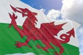 3D rendering of Wales flag waving on blue sky background