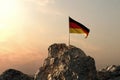3d rendering of waving German flag on rocky landscape