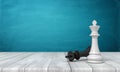 3d rendering of a white chess king standing near a fallen black king on a wooden desk background. Royalty Free Stock Photo