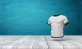 3d Rendering Of White Close-fitting Men`s T-shirt With Black Edge Piping, Suspended In Air Above Wooden Surface On Blue